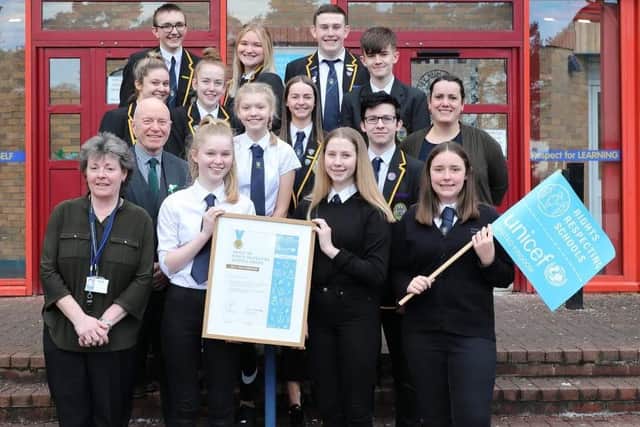 Kirkcaldy High School was awarded the UNICEF "Gold" Rights Respecting status in 2020. Pictured are staff and pupils outside the school. Pic: Andrew Reekie.