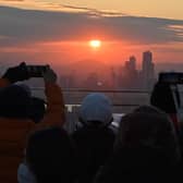 People enjoy the last sunset of the year on a viewing deck at Namsan tower in Seoul on December 31, 2020.