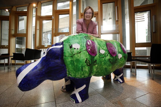 In 2011,  the Hippos went to the Scottish Parliament.
Presiding Officer Tricia Marwick MSP is pictured in the Garden Lobby with one of the hippos from the Glenrothes Hippo parade.