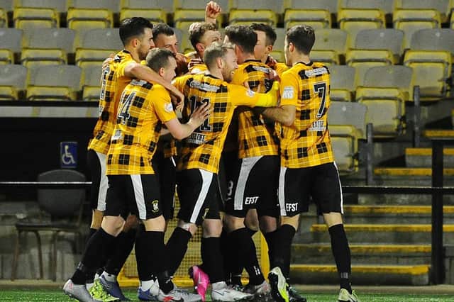 East Fife's players celebrate in front of an empty stand last season....but that will change soon. Pic by Michael Gillen