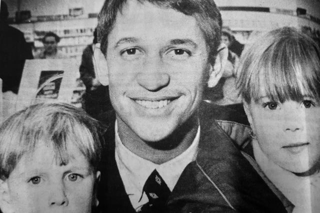 Football star turned broadcaster, Gary Lineker mad a surprise visit to RS McColl’s in the Kingdom Centre, Glenrothes in 1996, to promote Walkers crisps.
Crowds gathered outside the newsagent to meet the superstar who admitted he had never been the town before.
The visit was not publicised in advance so there were fewer youngsters than perhaps expected, but no shortage of mums and dads all eager to grab an autograph.
Gary is pictured with Nursery Ladybird youngsters Shaun Hutton and Ainslie Thomson, aged four.