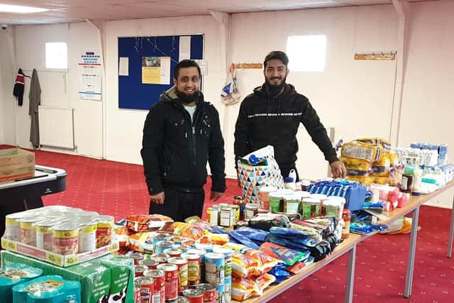 Imam Mansoor Mahmood and Imam Hafiz Shoaib with food ready for delivery.