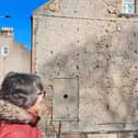 AIA trustee Elizabeth Riches at the shelled wall overlooking the Dreel Burn in Anstruther.  (Pic: submitted)