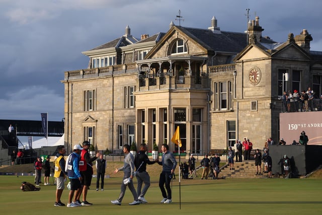 General view on the 18th green as Rory McIlroy of Northern Ireland, Collin Morikawa and Xander Schauffele of the United States shake hands during Day Two of The 150th Open at St Andrews Old Course on July 15, 2022 in St Andrews, Scotland. (Photo by Warren Little/Getty Images)