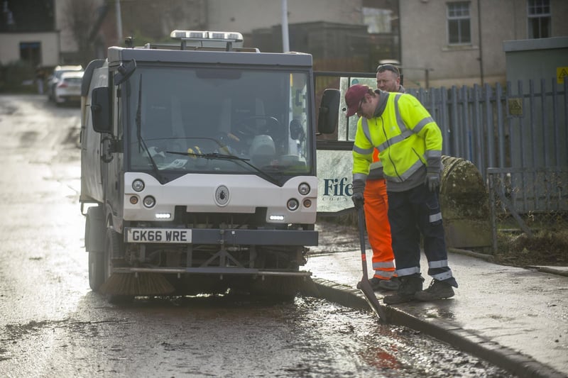 Fife Council crews tackle one of the flooded roads in Cupar.