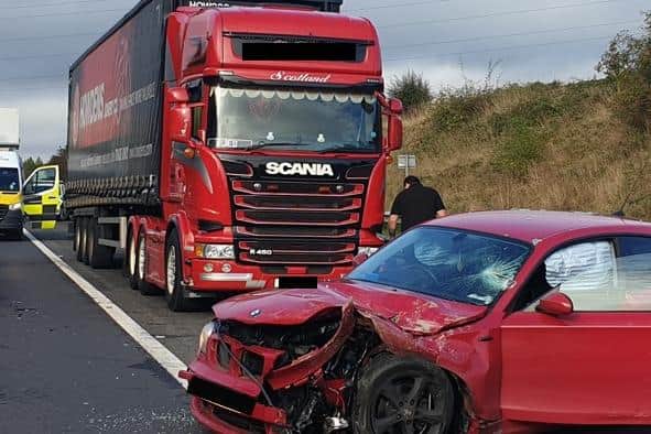 The crash between a lorry and a red BMW car happened on the M90 in Fife on Tuesday afternoon and one man was arrested (Photo: Police Scotland).