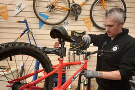 David Glover, refurbishing a bike at Lang Toun Cycles, has called on donations from the community ahead of the festive period