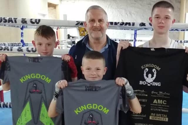 George Forrester presents the three Irish brothers with Kingdom Boxing Club T-shirts
​