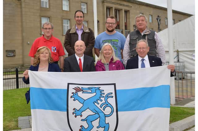 Robert Main Hoists the Inglostatd Flag at the Town House in 2018.
From left, James Cooper Ally Moghimian James Wallace Les Soper 
Front Cllr Carol Lindsay Cllr Neil Crooks Alice soper.