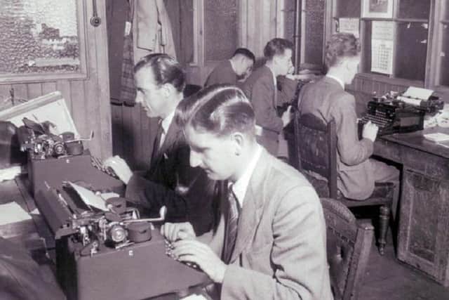 Fife Free Press newsroom with journalists working on stories on typewriters. Date unknown.