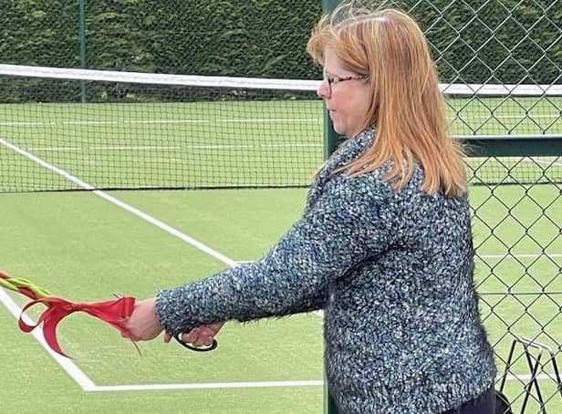 Councillor Margaret Kennedy formally opening the new courts by cutting the ribbon