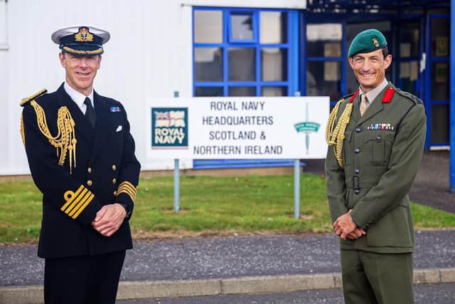 Captain Chris Smith RN (left) hands-over to Brigadier Andy Muddiman RM.