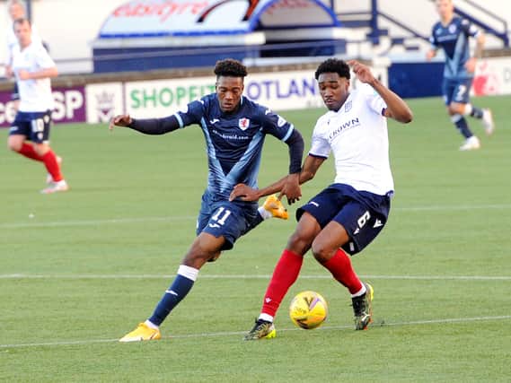 Timmy Abraham challenges with Dundee's Malachi Fagan-Walcott