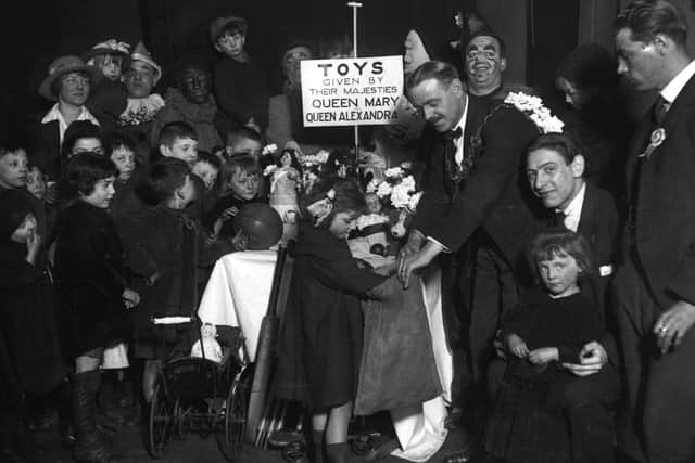 A group of orphans receiving Christmas gifts in East London.  (Photo by Topical Press Agency/Getty Images)