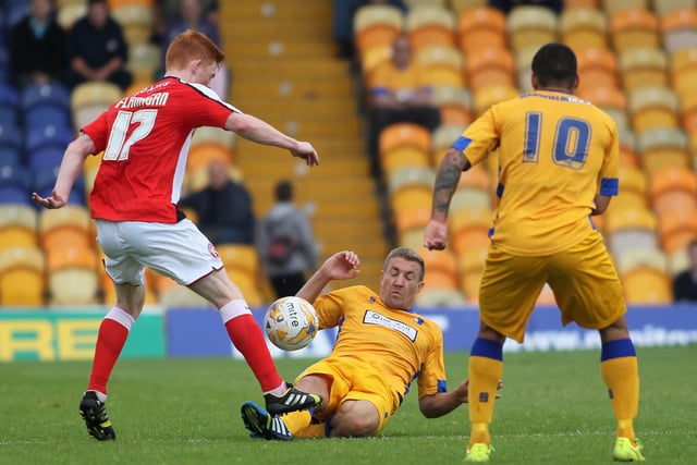 Mansfield's Simon Heslop tackles Walsall's Reece Flanagan in a 0-0 pre-season friendly draw in August 2014.