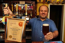 Jon Stanley behind the bar at the Harbour Bar  (Pic: Fife Photo Agency). Inset: The pub's first award