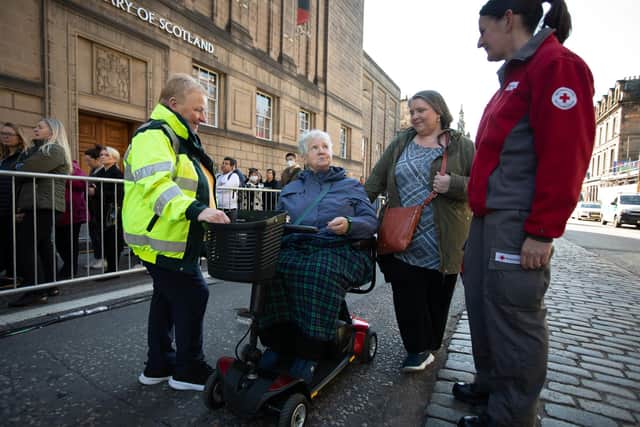 Irene Guild (left) helped members of the public who were queuing to pay their respects to Her Majesty the Queen as she lay in state at St Giles' Cathedral last year.