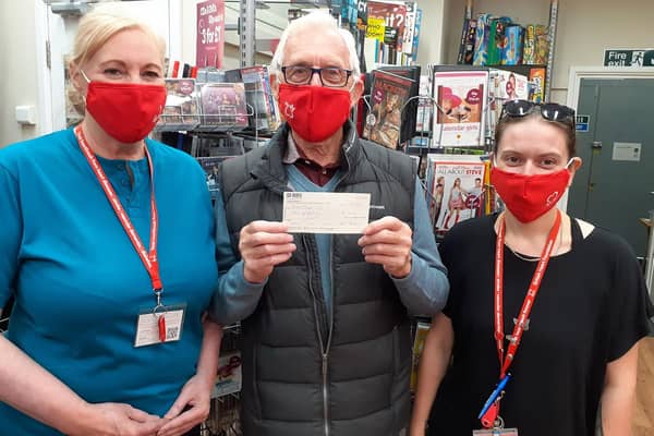 Bill Ewan visits the BHF shop in Glenrothes to hand over a cheque