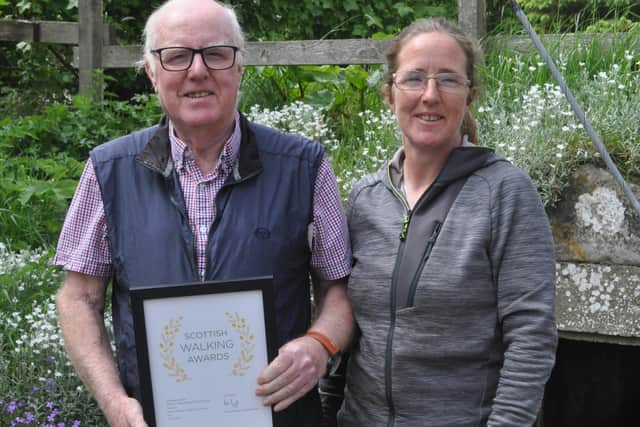 From left: Bob Cooper, operations manager at Alcan and Hayley MacDonald, health and safety officer at Alcan with the walking award.