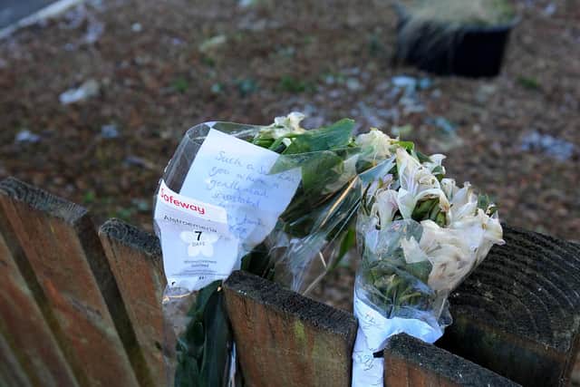 One of the floral tributes on a fence outside his former home. Pic: Walter Neilson