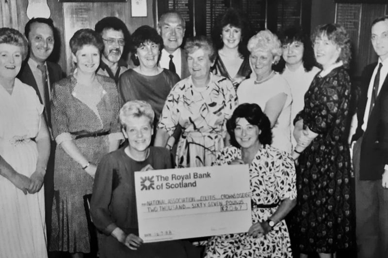 July 1988 saw a big cheque handed over at Markinch Bowling Club to the National Association for Colitis and Crohn’s Disease. It was raised via a sponsored walk. Making the presentation is Mrs Gillian Hamer-Hodges (right) to Mrs Christine Munro, with some of the walkers in the background Picture taken by Robert Mackie, freelance photographer, Kirkcaldy.
