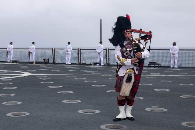 British Army Colour Sgt. James Muir, with the Pacific Partnership Band, plays the bagpipe on the flight deck of USS Pearl Harbor  (*Pic: Mass Communication Specialist 2nd Class Deirdre Marsac)
