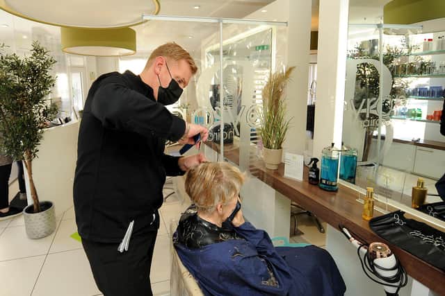 Ronnie Marshall, owner of Byron Hairdressing, working on a client in the salon which re-opened on Monday. Pic: Fife Photo Agency