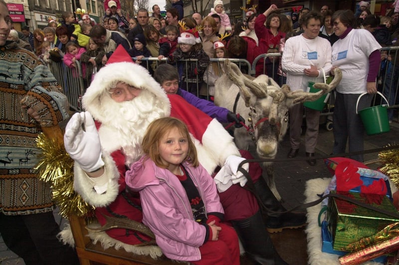 Each year, one lucky competition winner would ride on Santa's sleigh during the parade.