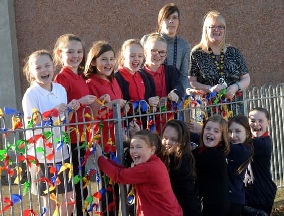 Pitteuchar East Primary School, Glamis Avenue, Glenrothes -  pupils putting their respect ribbons on the school fence as part of a week of learning about respect  for others