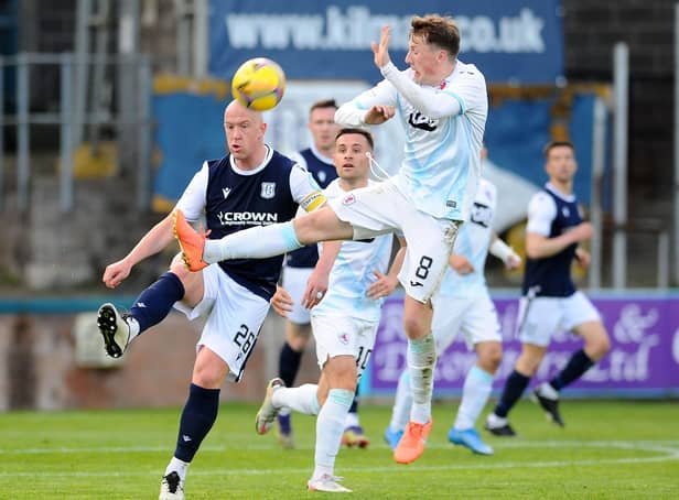 Regan Hendry challenges for the ball with Dundee's Charlie Adam (Pic: Michael Gillen)