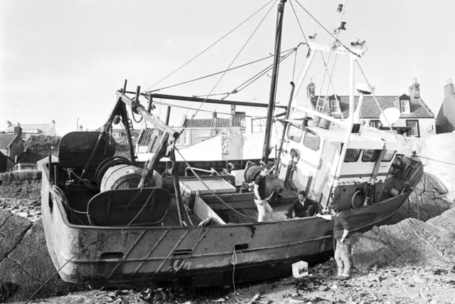 Ronnie Morrison working out the best way to refloat the Lady Mabb fishing boat, which was grounded at St Monans beach in Fife, October 1988.