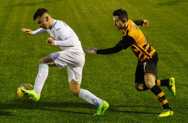 Dan Armstrong on the charge for Raith Rovers, pursued by Alloa's Kevin Cawley.