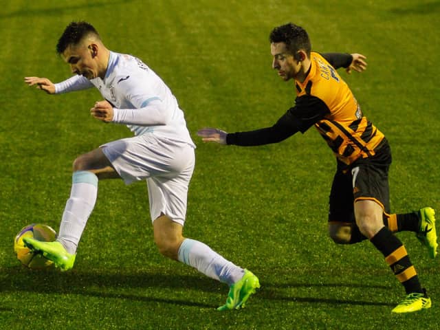 Dan Armstrong on the charge for Raith Rovers, pursued by Alloa's Kevin Cawley.