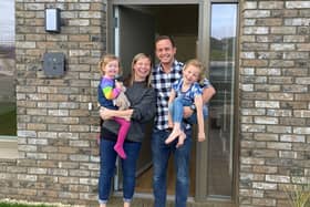 The first residents at St Andrews West, Rona and Mark Patterson, plus their children, are pictured in front of their new home (Pic: Submitted)