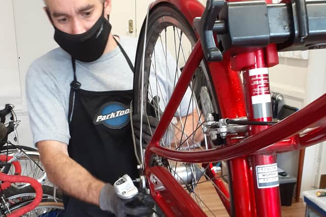 Stewart Murray, bike mechanic, carrying out repairs.