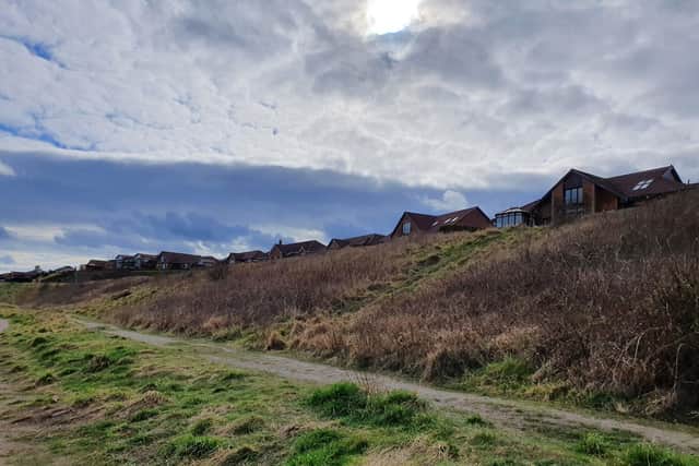 The houses will sit on this land which currently slopes down towards the coastal path.