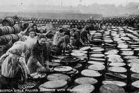One photograph features so-called 'Scotch girls' filling whisky barrels with herring. Picture: Scottish Fisheries Museum