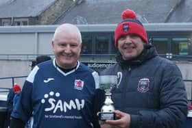 Scott Jackson, chairman of Kirkcaldy & Dysart FC, presents the trophy to Raith Captain Ian McMillan