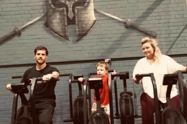 Sam and Huw with their son. They are the owners of Strength Lab Crossfit in Kirkcaldy.