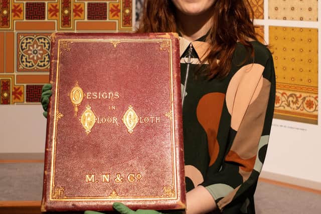 Lily Barnes, OnFife's project engagement curator, with one of the pattern books from the collection. Picture: OnFife