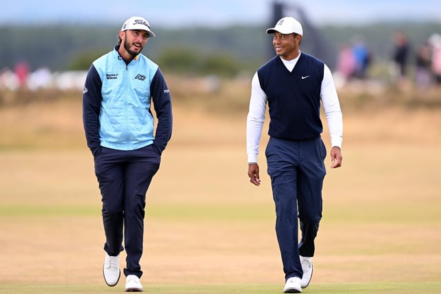Max Homa and Tiger Woods of The United States interact during Day One of The 150th Open at St Andrews Old Course on July 14, 2022 in St Andrews, Scotland. (Photo by Ross Kinnaird/Getty Images)