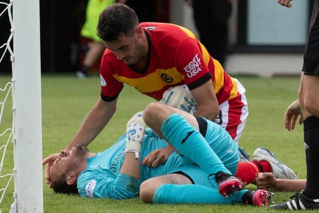 Partick Thistle's Brian Graham attending to Raith Rovers goalkeeper Jamie MacDonald after they collided during their sides' Scottish Championship match on Saturday at Firhill Stadium in Glasgow (Photo by Mark Scates/SNS Group)