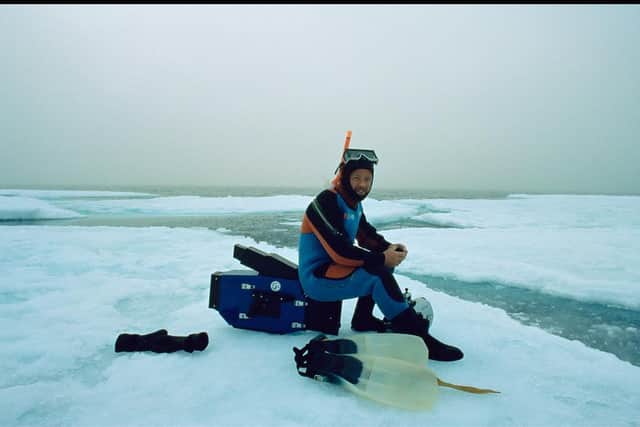 Doug Allan preparing to film beneath the ice in Canadian Arctic. June 1995