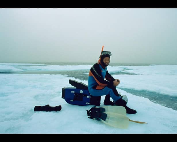 Doug Allan preparing to film beneath the ice in Canadian Arctic. June 1995