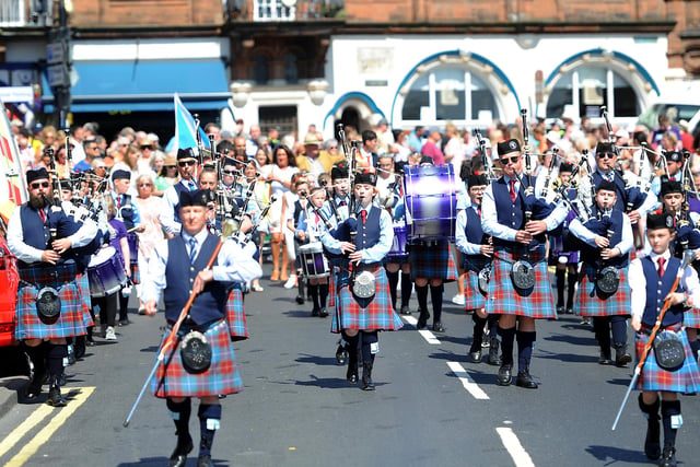 The pipes and drums lead the parade through the High Street to the games arena on The Links