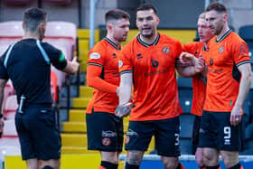 Dundee United's Tony Watt picks up a glass bottle thrown by the Raith Rovers fans as he celebrates after he scores to make it 1-0 against Raith Rovers at Tannadice (Pic Ewan Bootman/SNS Group)