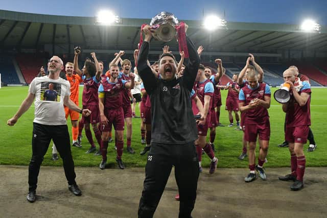 Cupar Hearts boss Sean Simpson celebrates in front of the support that travelled to the National Stadium on Wednesday night