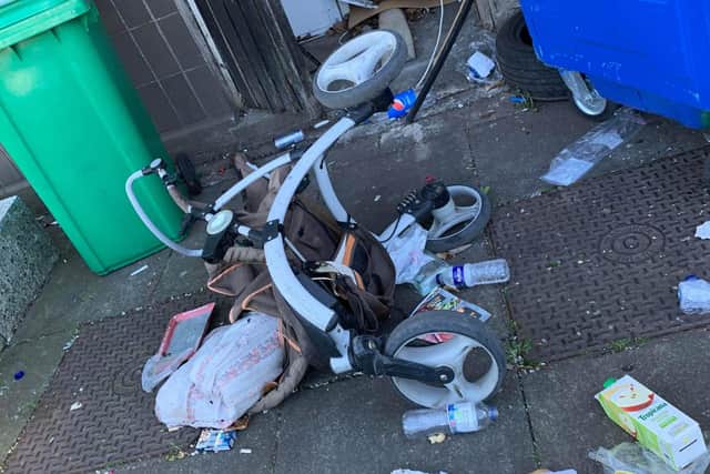 The dumped rubbish around the flats in Waverley Court included a child's buggy.