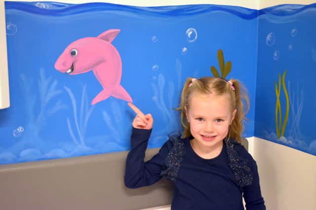 Poppy in front of the new mural she helped fund at the Victoria Hospital (Pic: Submitted)