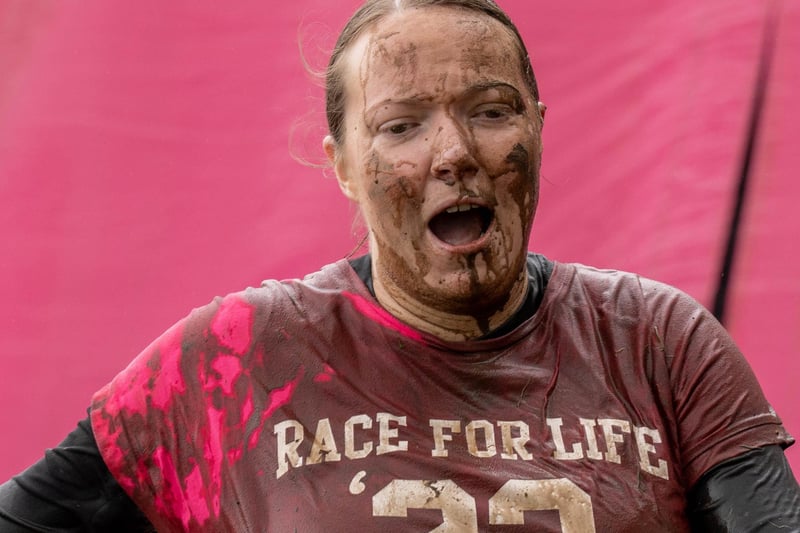A muddy competitor heads to the finishing line